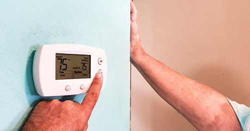 Image: a sneaky set of hands changes the thermostat settings without telling anyone.