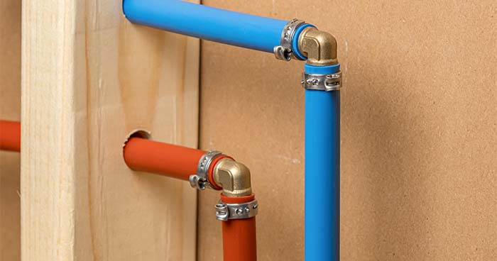 Image: two PEX pipes, one blue pipe for cold water and one red pipe for warm water.